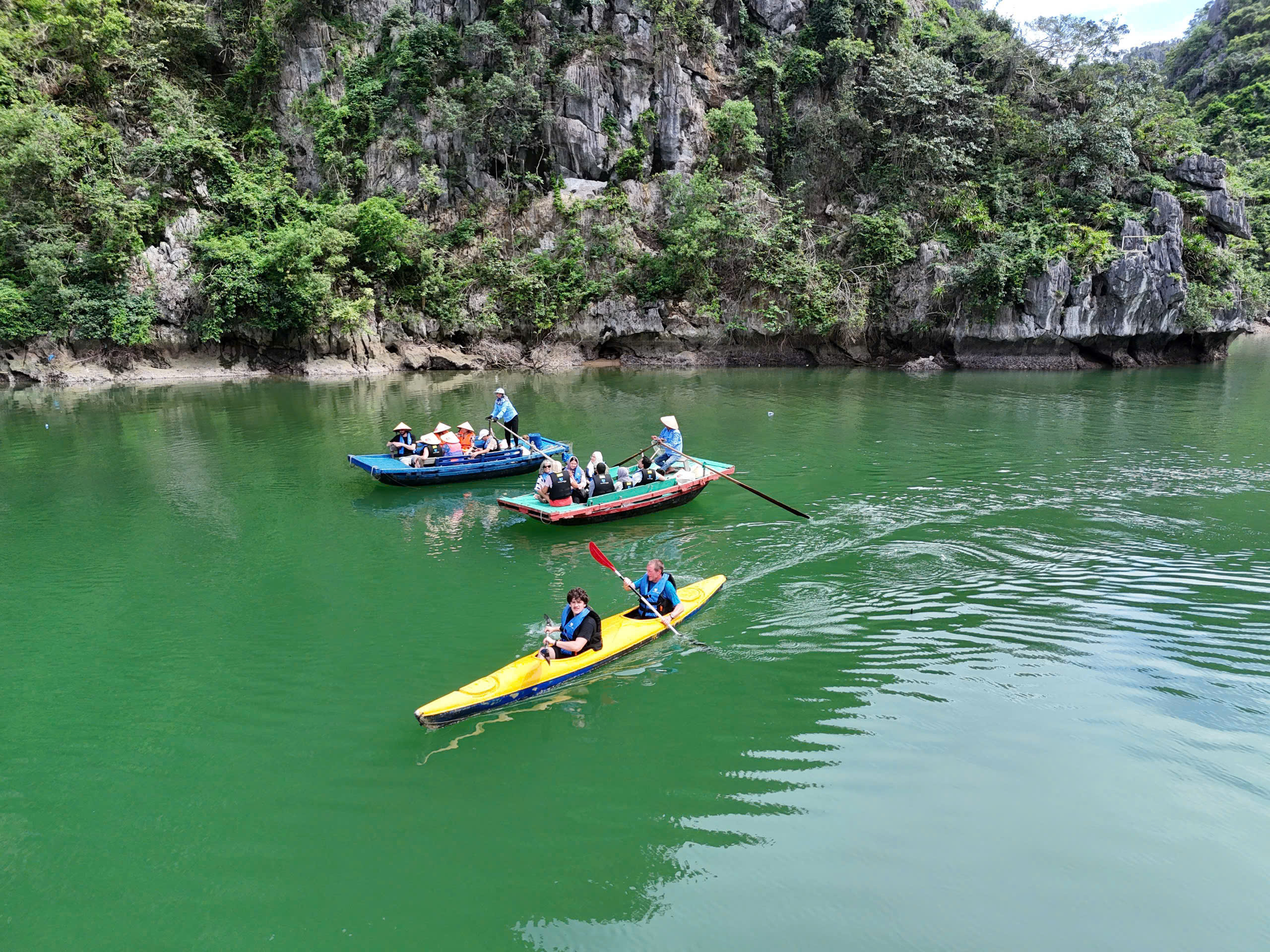 Kayaking or sitting on bamboo boat to visit Bright - Dark Cave
